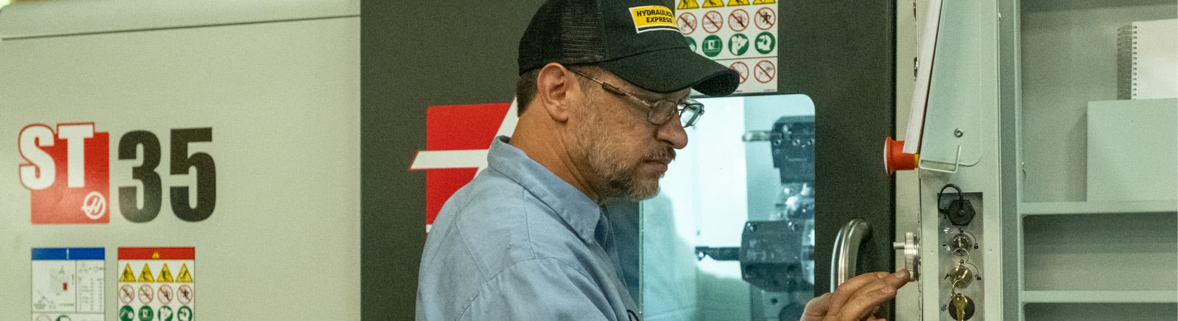 Person working a CNC Lathe.